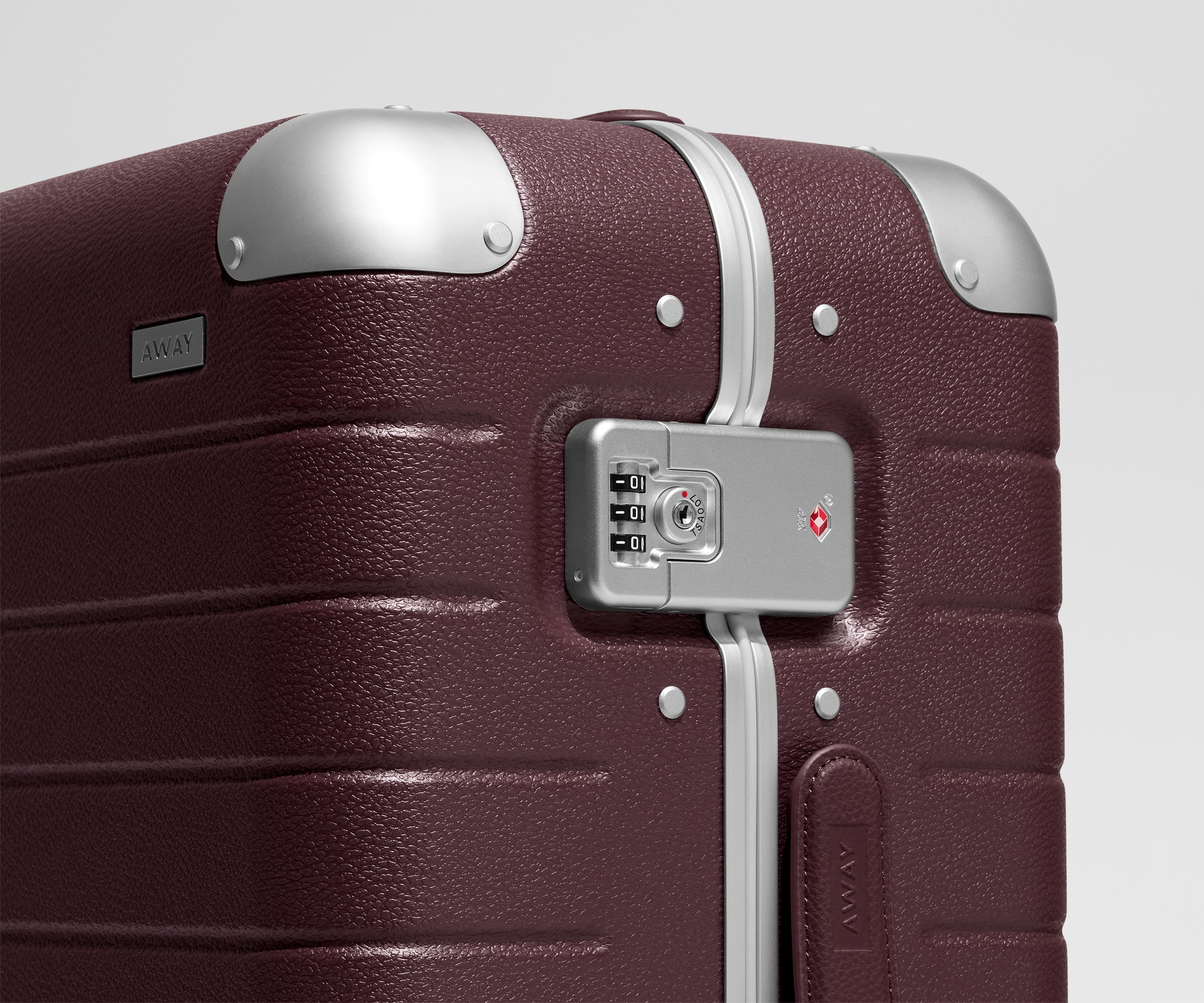 The Aluminum Edge Bigger Carry-On in Oxblood Red