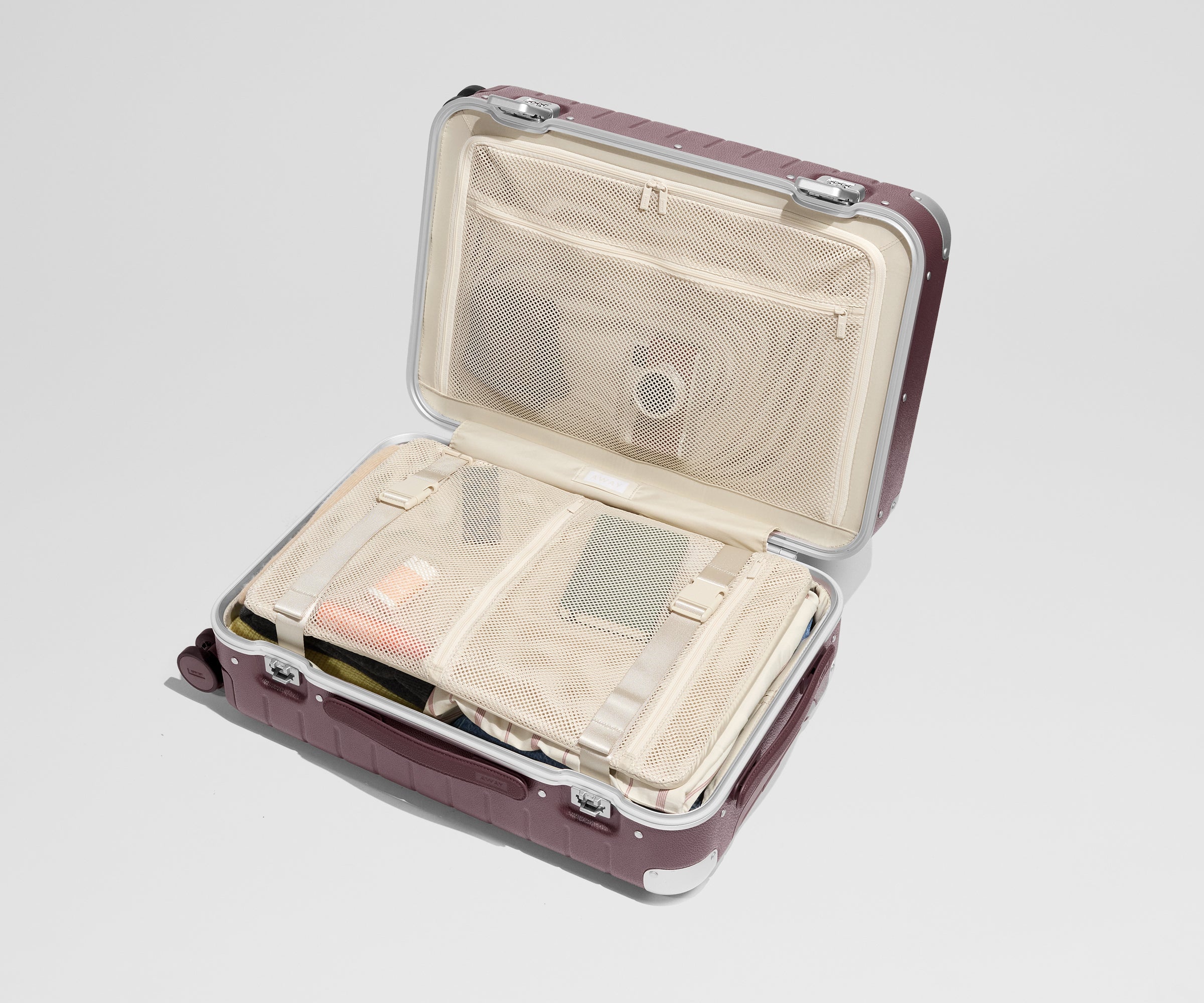 The Aluminum Edge Bigger Carry-On in Oxblood Red